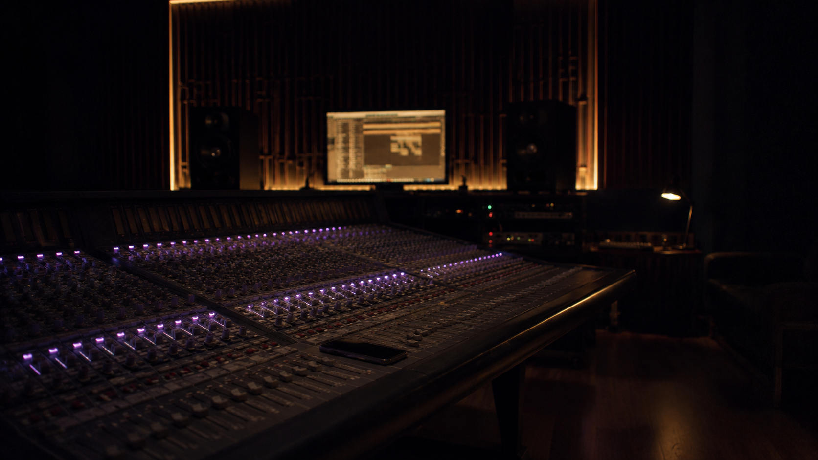 AUVIO — dark recording studio with mixing console, monitors, and analog warmth